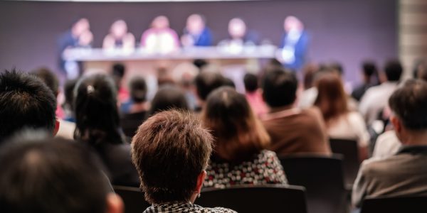 Rear view of Audience in the conference hall or seminar meeting which have Speakers are Brainstorming